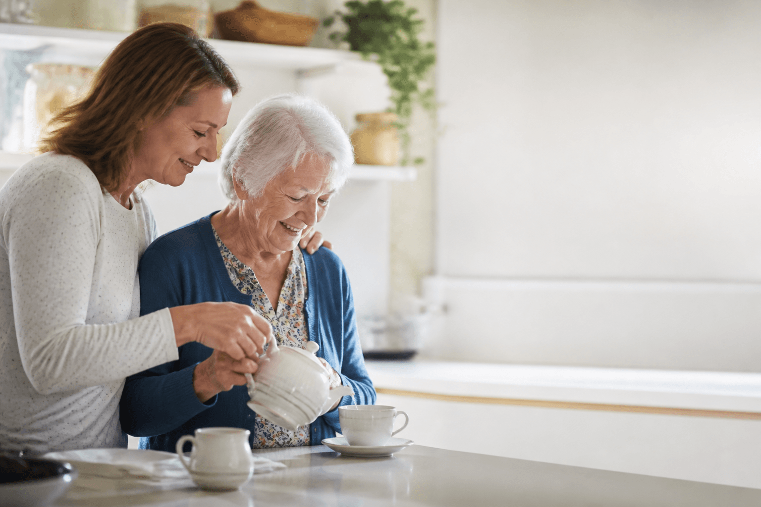An adult child and an older parent sharing a calm moment at home.
